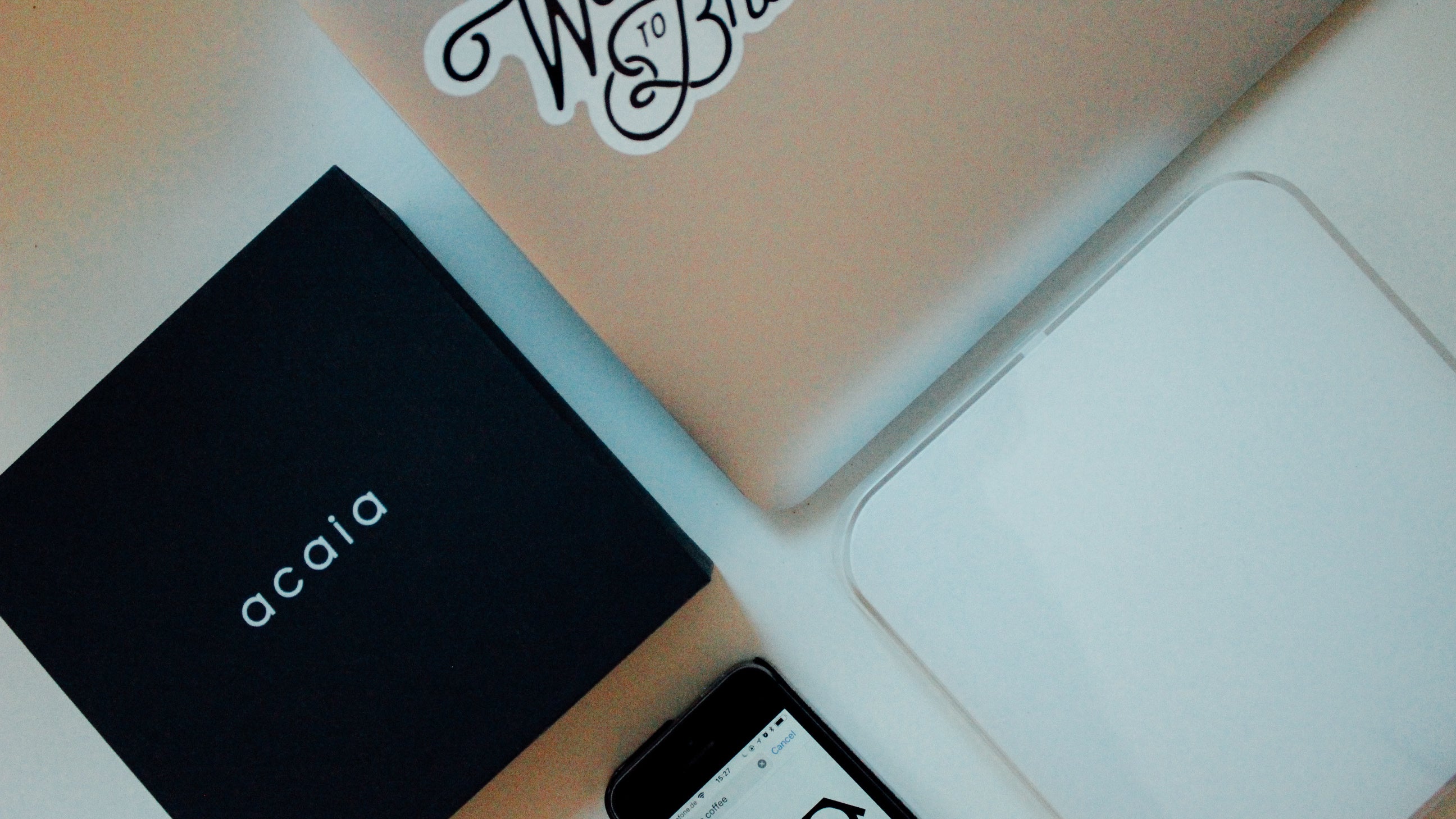 A laptop, an iphone, an Acaia box and Pearl scale.