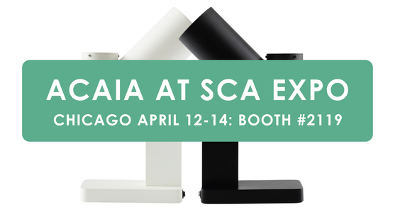 Green Banner Saying Acaia at SCA EXPO Chicago April 12-14 Booth #2119 over a white and black orbit