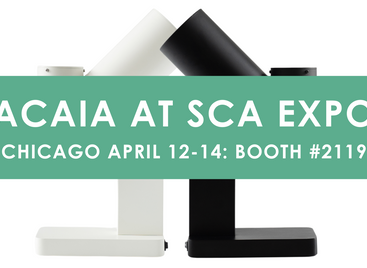 Green Banner Saying Acaia at SCA EXPO Chicago April 12-14 Booth #2119 over a white and black orbit