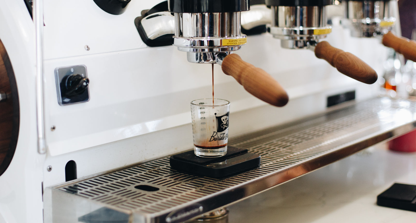 A Lunar scale measuring an espresso shot on a La Marzocco machine.