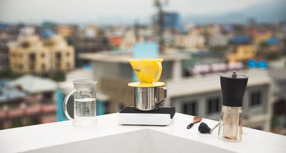 A Pearl Scale on the ledge of a building with other coffee equipment.